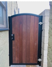a wooden gate with a black frame