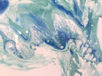 a close up of a blue and white painting