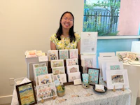 a woman standing in front of a table full of cards