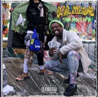 a man and woman posing for a photo in front of a billboard