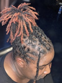 a woman with dreadlocks in her hair