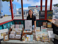 a woman standing in front of a table full of cards