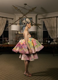 a woman in a dress standing in a room