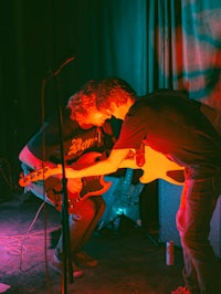 a group of people playing guitars in a room