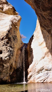 a waterfall coming out of a cave