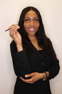 a woman in a business suit holding a brush