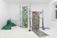 a white room with several pieces of art on the floor
