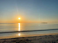 the sun is setting over a body of water