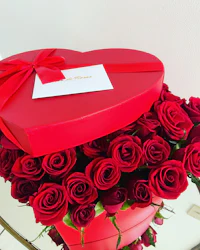 red roses in a heart shaped box