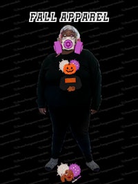 a woman wearing a black sweater with a pumpkin on it