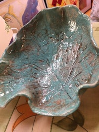 a bowl with a leaf on it on a table