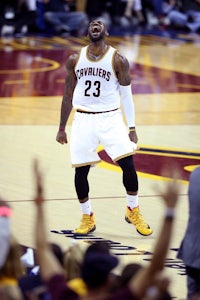 the cleveland cavaliers player celebrates with his hands up
