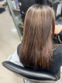 the back of a woman's hair in a salon