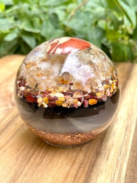 a glass sphere with sand and minerals inside