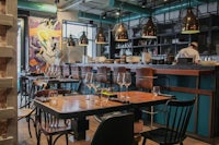 the interior of a restaurant with tables and chairs