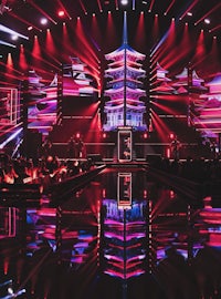 a stage with red and blue lights in the background