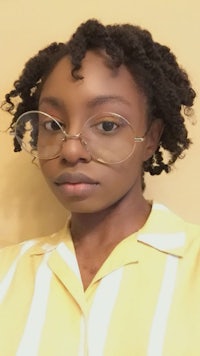 a woman wearing glasses and a yellow shirt