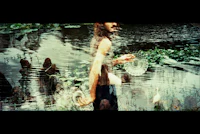 a man holding a frisbee in the water