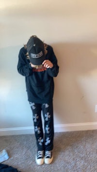 a person standing in a room with a hat on his head