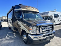 a brown rv parked in a parking lot