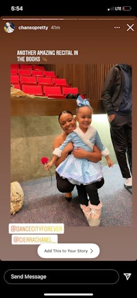 a woman is holding a child on her phone