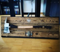 a wooden frame with an axe on it