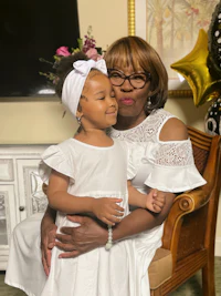 a woman in a white dress and a little girl in a white dress