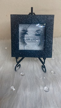 a black frame with a picture of eyelashes on it