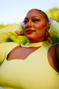 a woman in a yellow dress posing for a photo
