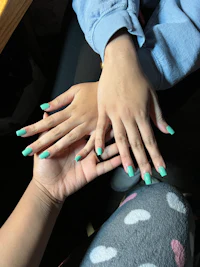 a pair of hands holding each other's nails
