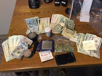 a large amount of money and a cell phone on a table