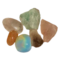a group of different colored stones on a black background