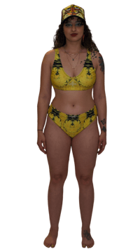 a woman in a yellow bikini and hat