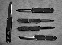 a black and white photo of a group of knives