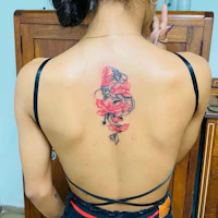 the back of a woman with a flower tattoo