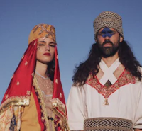 a man and woman in traditional clothing standing next to each other