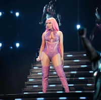 nicki minaj performs on stage in a pink outfit