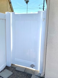 a white gate in front of a house