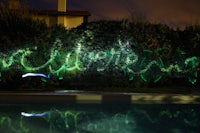 a light painting on a wall near a pool