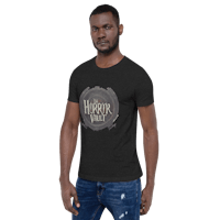 a man wearing jeans and a black t - shirt