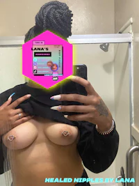 a woman is taking a picture of her breasts in a mirror