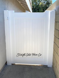a white gate in front of a house