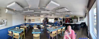 the inside of a restaurant with tables and chairs