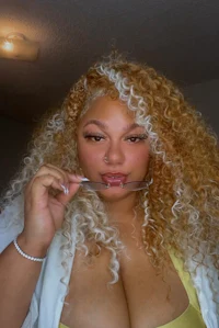 a woman with curly hair brushing her teeth