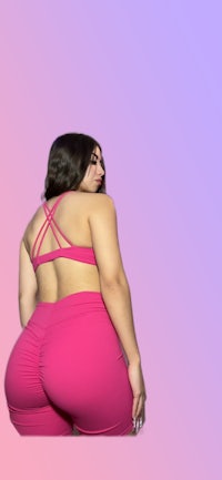 a woman in a pink bikini posing with her back to the camera