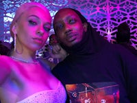 a man and a woman posing for a photo at a party
