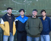 a group of men standing in front of a building