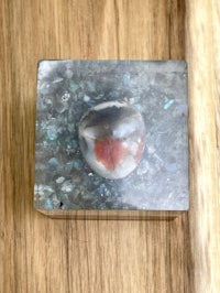 a small box with a stone in it