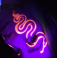 a woman with a glowing snake on her face