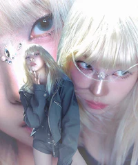 a girl with blond hair is posing for a photo